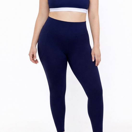 Woman wearing french navy blue leggings and matching sports bra 