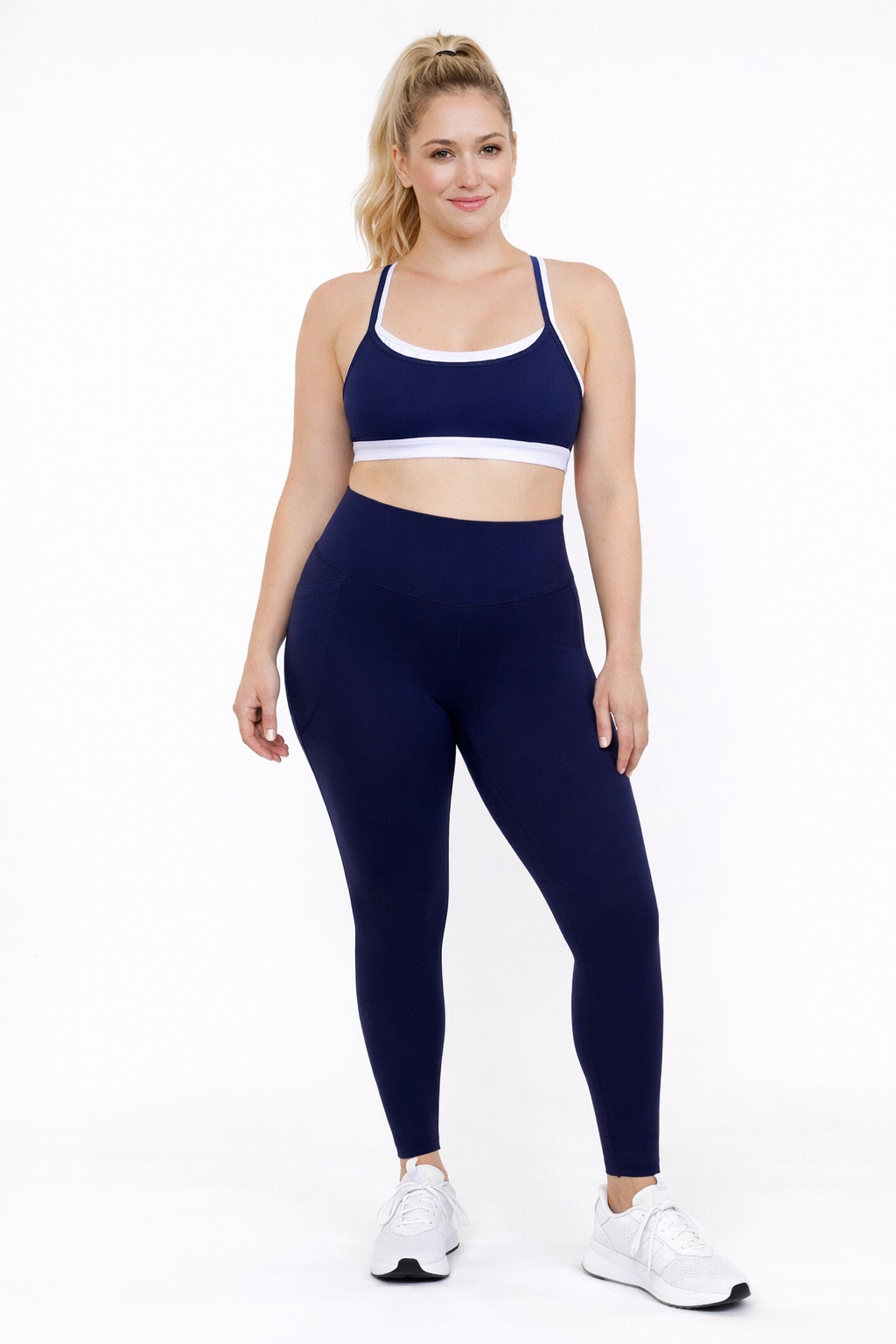 Woman wearing french navy blue leggings and matching sports bra 