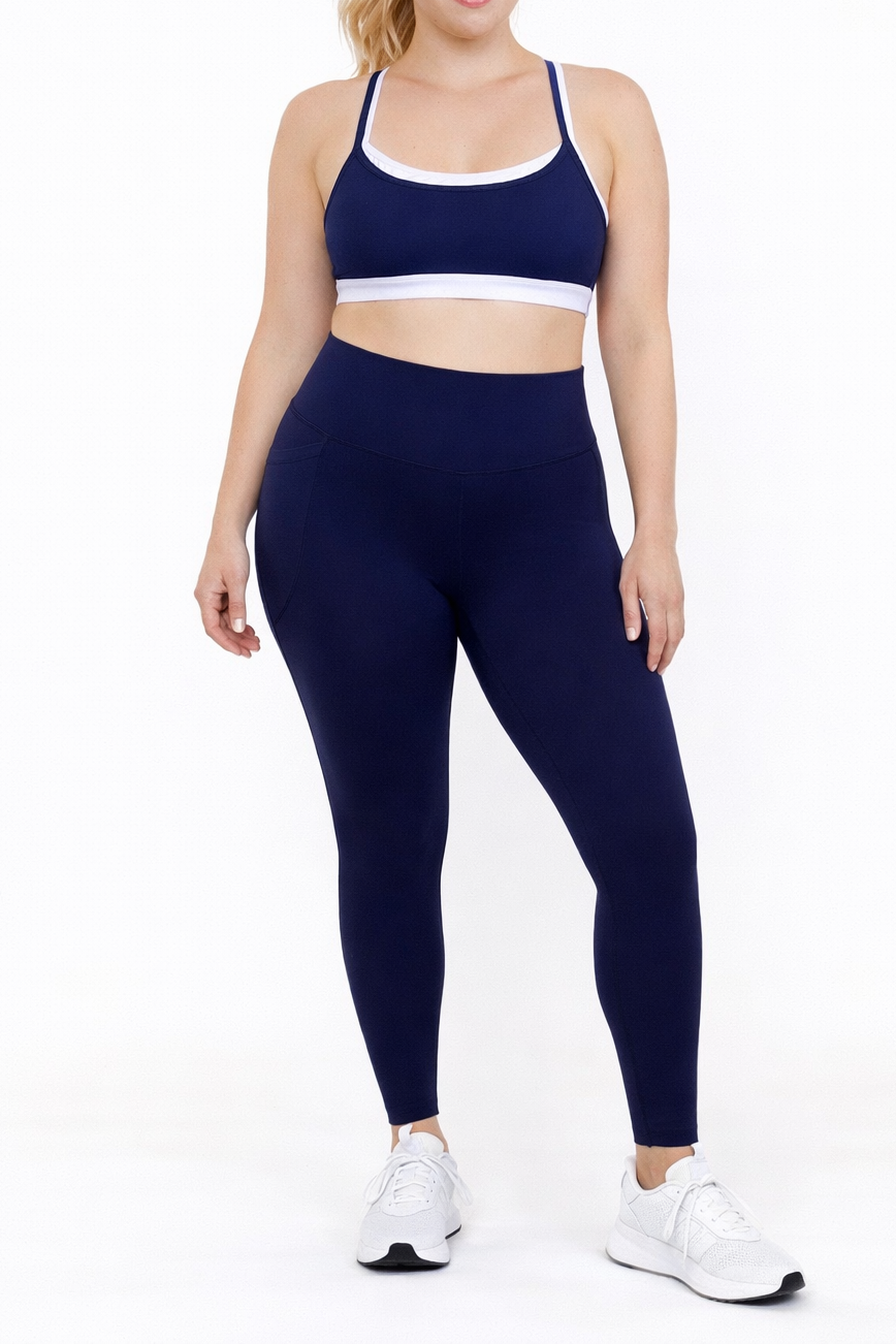 Woman wearing french navy blue leggings and matching sports bra 