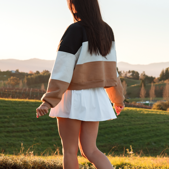 old money paneled over sized sweater and white pleat skirt