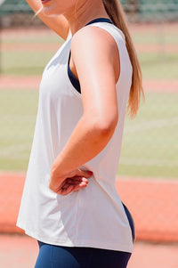 Women wearing a white relaxed sleeveless singlet.