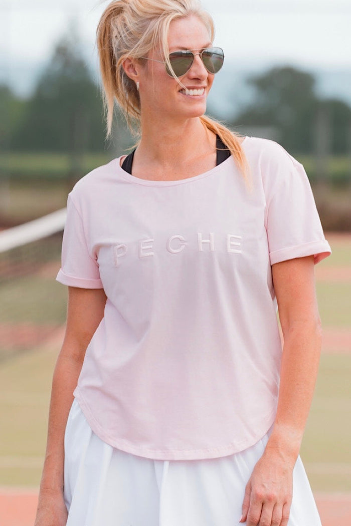Women wearing pink scoop neck t-shirt