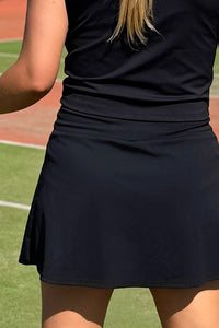 Women wearing black pickle ball skort.