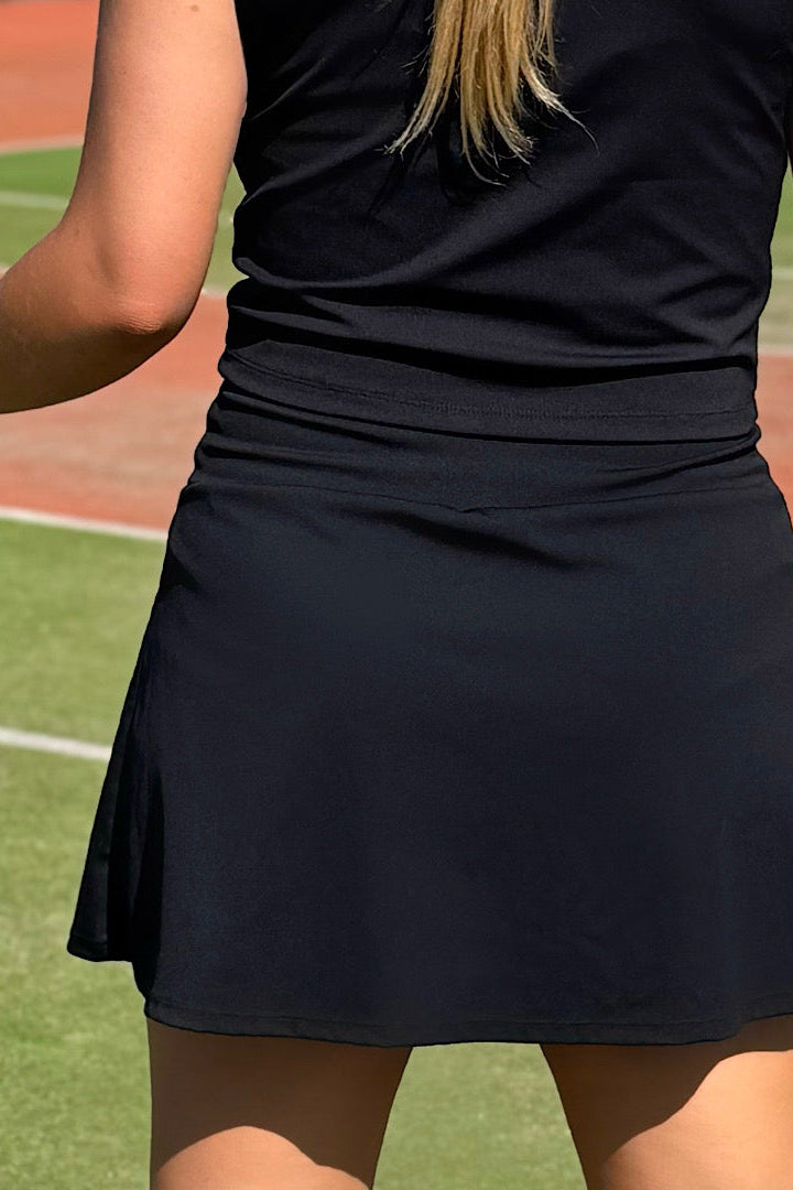 Women wearing black pickle ball skort.