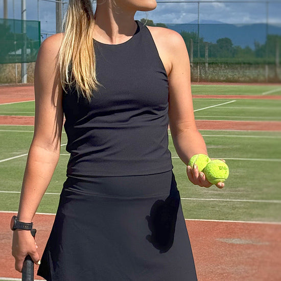 Women wearing black golf skort.
