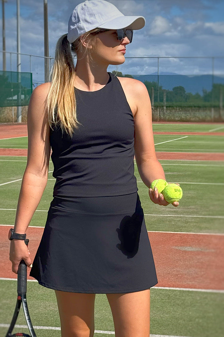 Women wearing black golf skort.