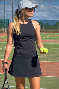 Women wearing black golf skort.