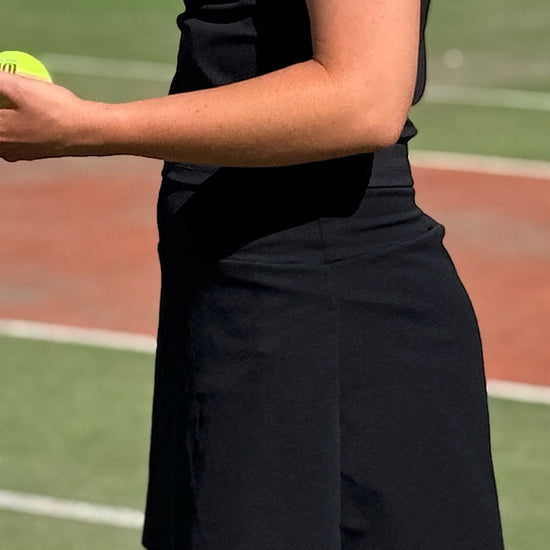 Women wearing black tennis skort.
