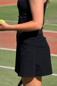 Women wearing black tennis skort.