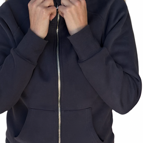 Woman wearing a navy blue zip-up hoodie.