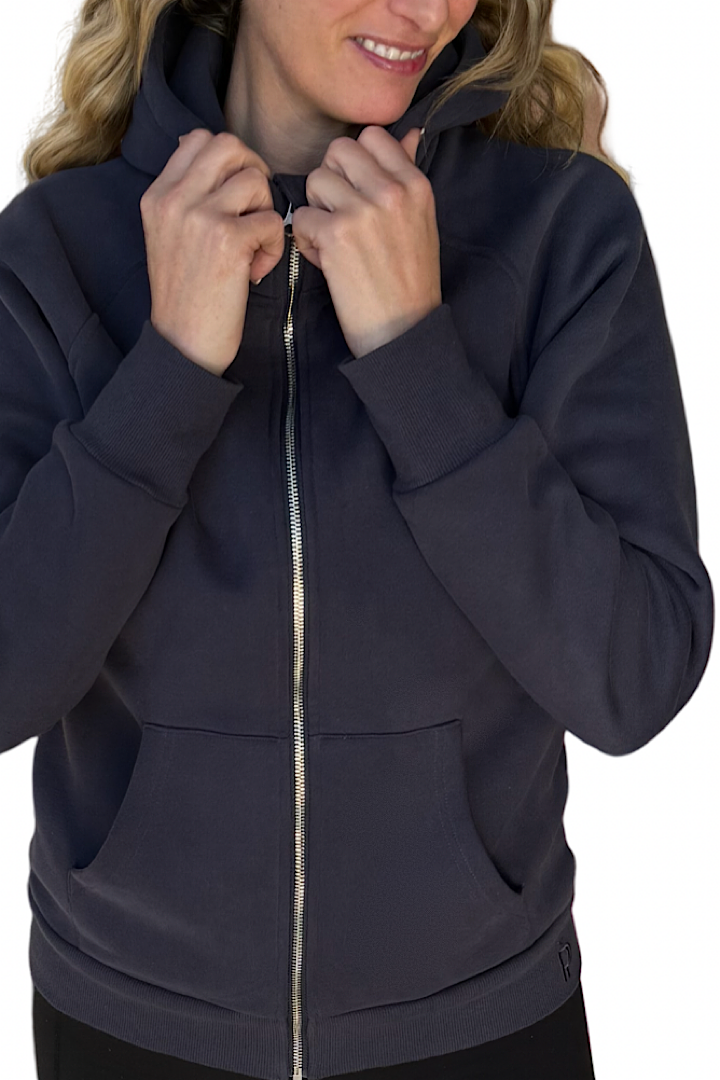 Woman wearing a navy blue zip-up hoodie.