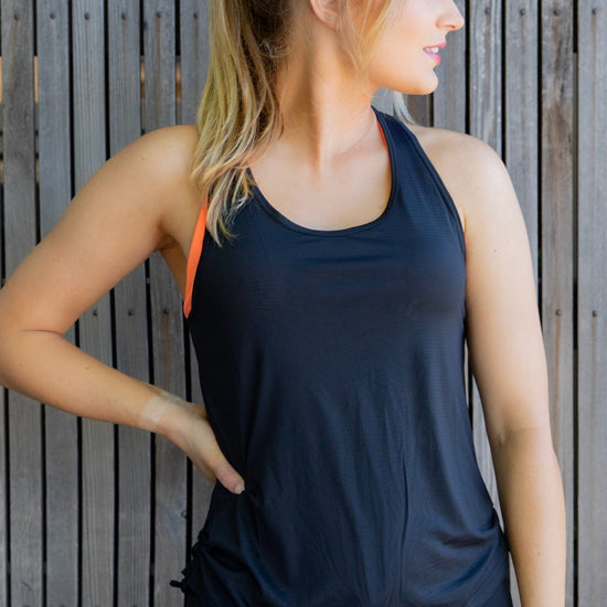 Women in black racer back black mesh singlet with orange bra 