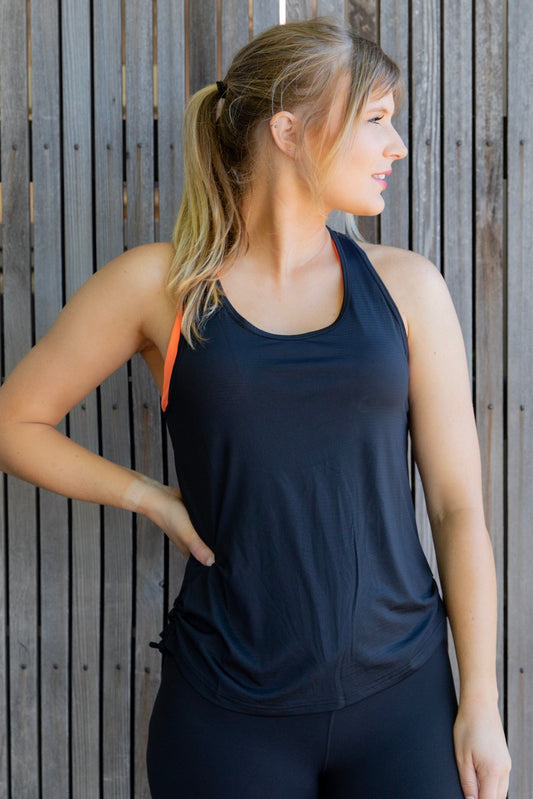 Women in black racer back black mesh singlet with orange bra 