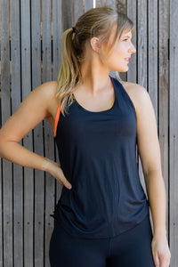 Women in black racer back black mesh singlet with orange bra 