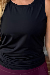 women wearing a black relaxed singlet.