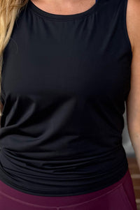 women wearing a black relaxed singlet.
