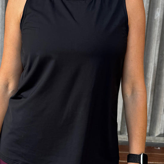 women wearing a black relaxed singlet.