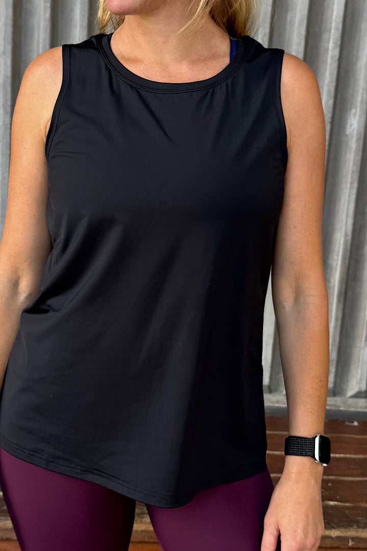 women wearing a black relaxed singlet.