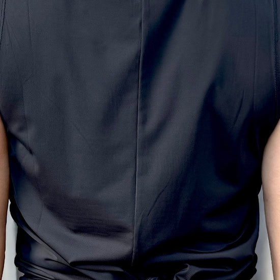 women wearing a black relaxed singlet.