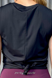 women wearing a black relaxed singlet.