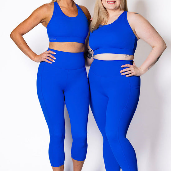 women wearing bright blue phone pocket leggings