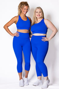 women wearing bright blue phone pocket leggings