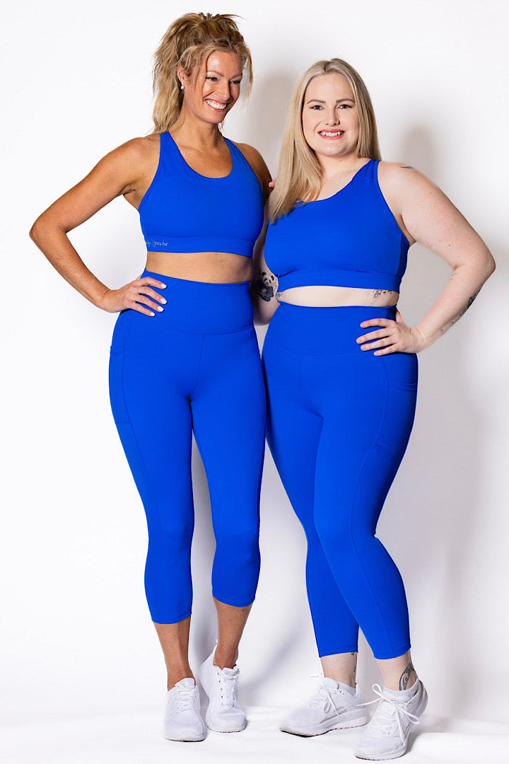 women wearing bright blue phone pocket leggings