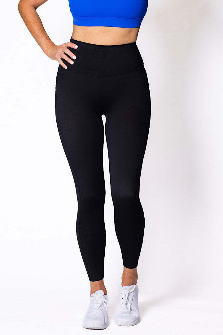 Women wearing high waist phone pocket tights with blue sports bra 