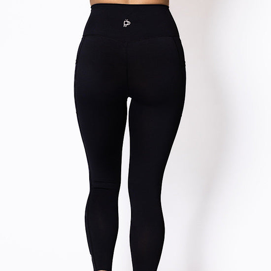 Women wearing high waist phone pocket tights with blue sports bra 
