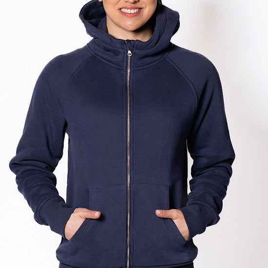 Woman wearing a navy blue hoodie.