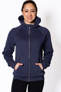 Woman wearing a navy blue hoodie.