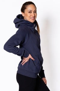 Woman wearing a zip through navy blue hoodie.