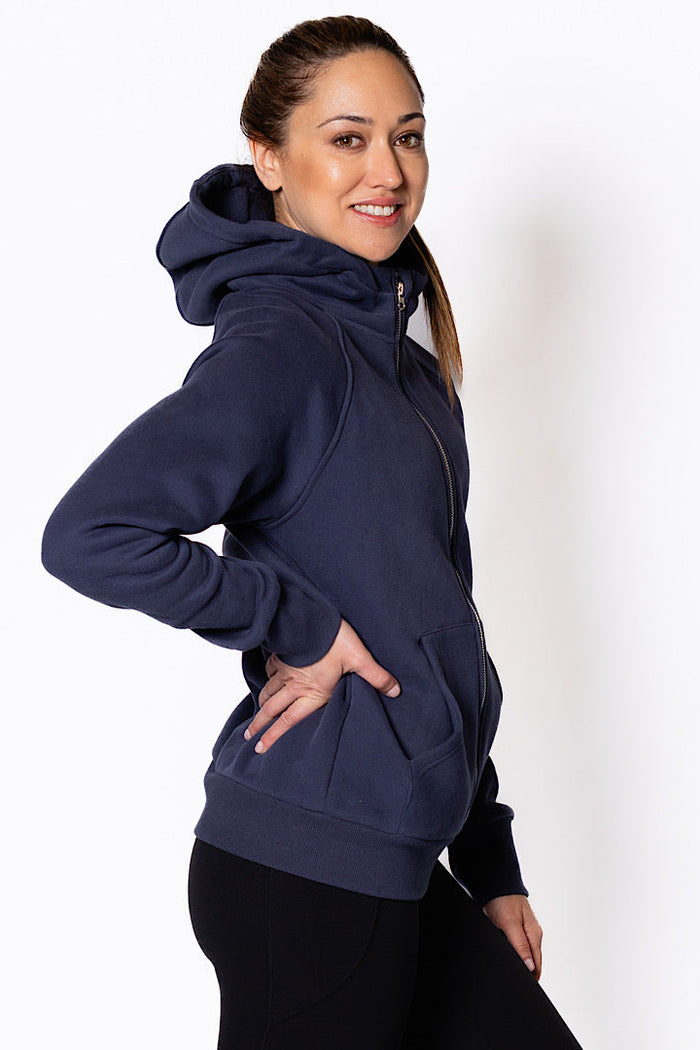 Woman wearing a zip through navy blue hoodie.