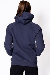Woman wearing a zip through navy blue jumper.