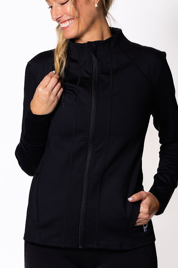 Woman wearing a black zip jacket