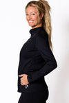Woman wearing a black long-sleeve top with a logo on a white background