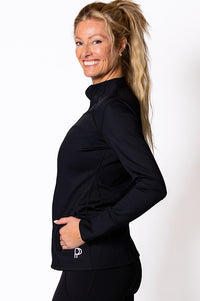 Woman wearing a black long-sleeve top with a logo on a white background