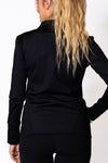 Woman wearing a black zip jacket
