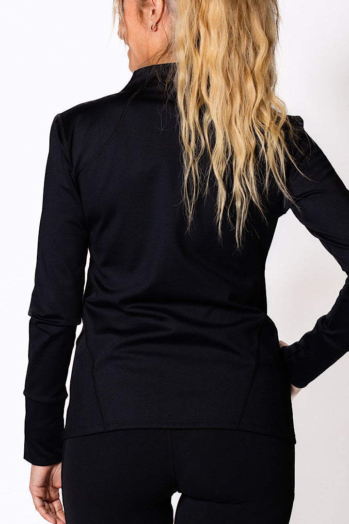 Woman wearing a black zip jacket