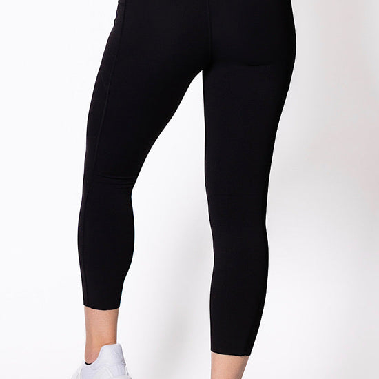 women wearing black 7/8 high waist phone pocket tights