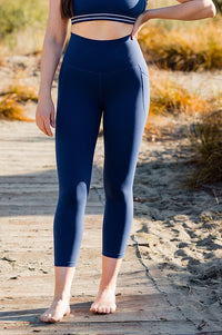 Women wearing navy blue soft leggings and navy sports bra.