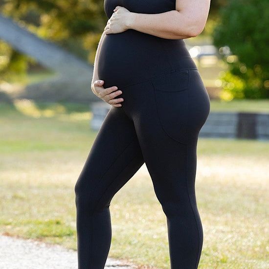 Pregnant woman wearing maternity leggings and maternity bra.