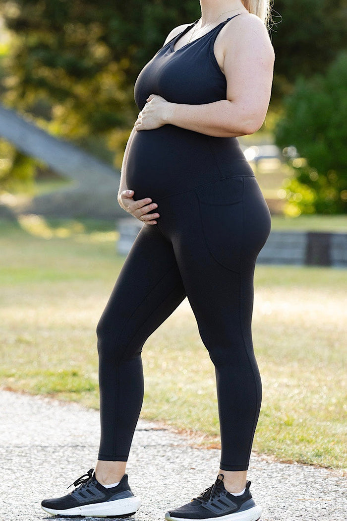 Pregnant woman wearing maternity leggings and maternity bra.