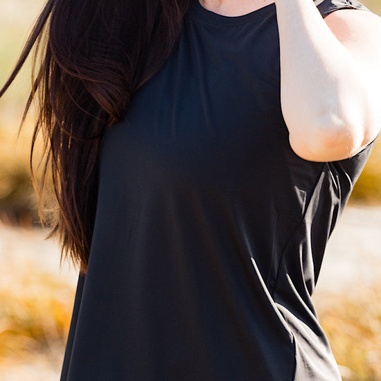 women wearing a black relaxed singlet.