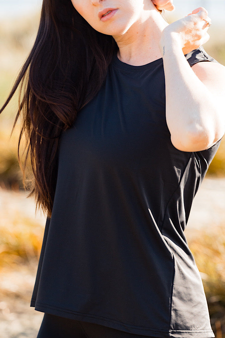 women wearing a black relaxed singlet.