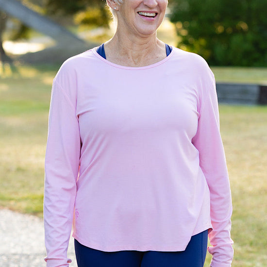 Mature woman wearing a pink long-sleeve top 
