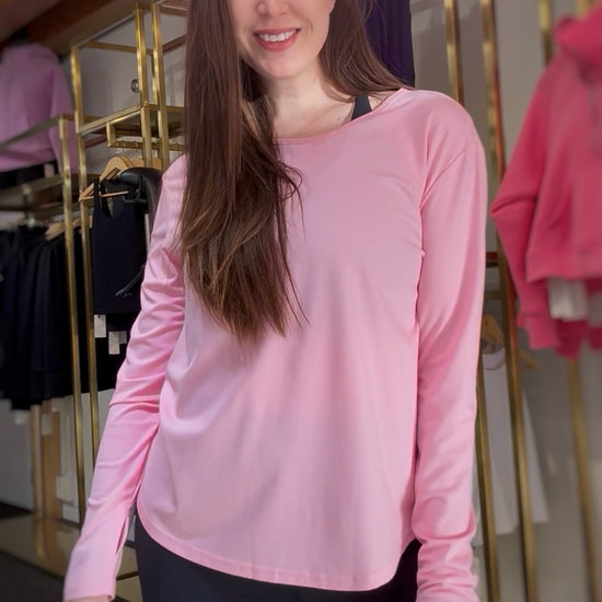 woman wearing a pink long-sleeve top 