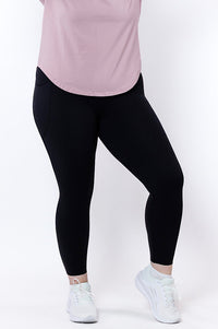 women wearing black leggings and a pink top on a white background