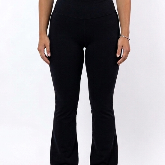 Woman wearing a black sports bra and flare leggings