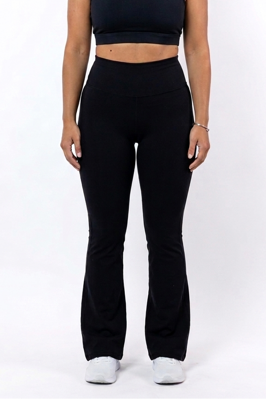 Woman wearing a black sports bra and flare leggings